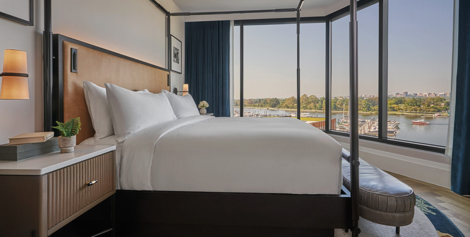 A king bed in a room with a Washington Harbor view at Pendry Washington DC &ndash; The Wharf