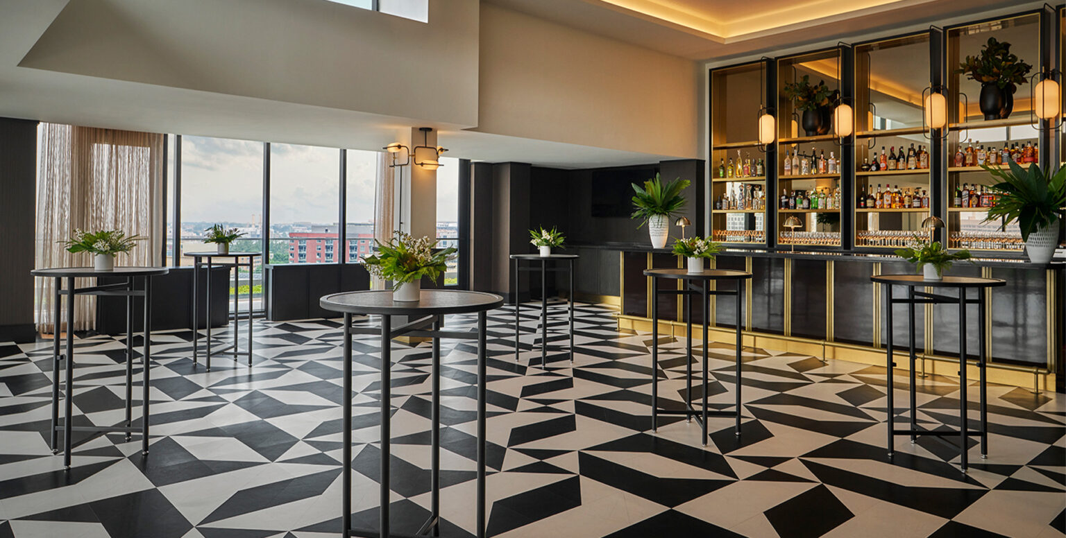 High-top tables placed around Moonraker at Pendry Washington DC &ndash; The Wharf